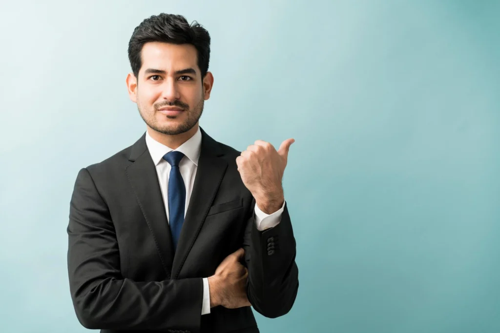Businessman in suit pointing, representing corporate sales training insights for CEOs.