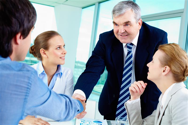 Team in business meeting during communication training with leader promoting effective leadership skills